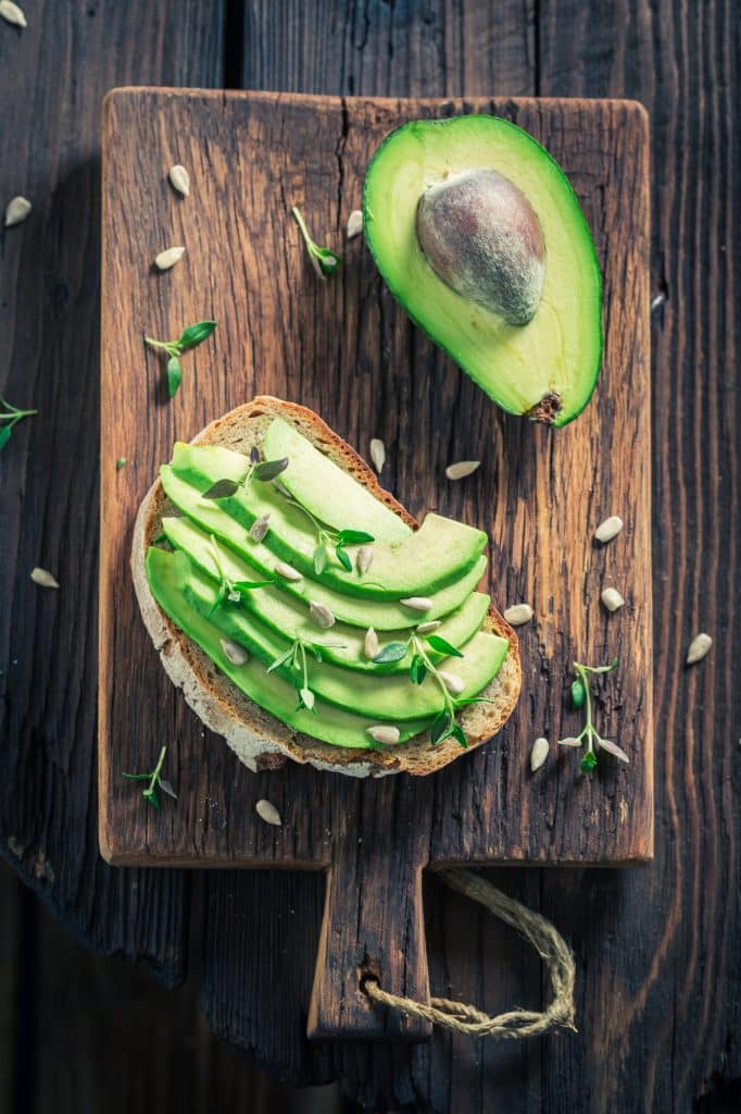 Whole and halved avocados