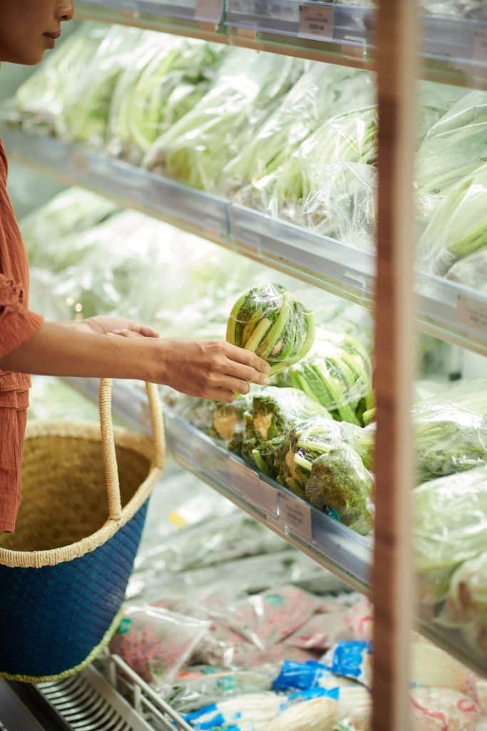 Shopping for fresh salad greens in the produce aisle