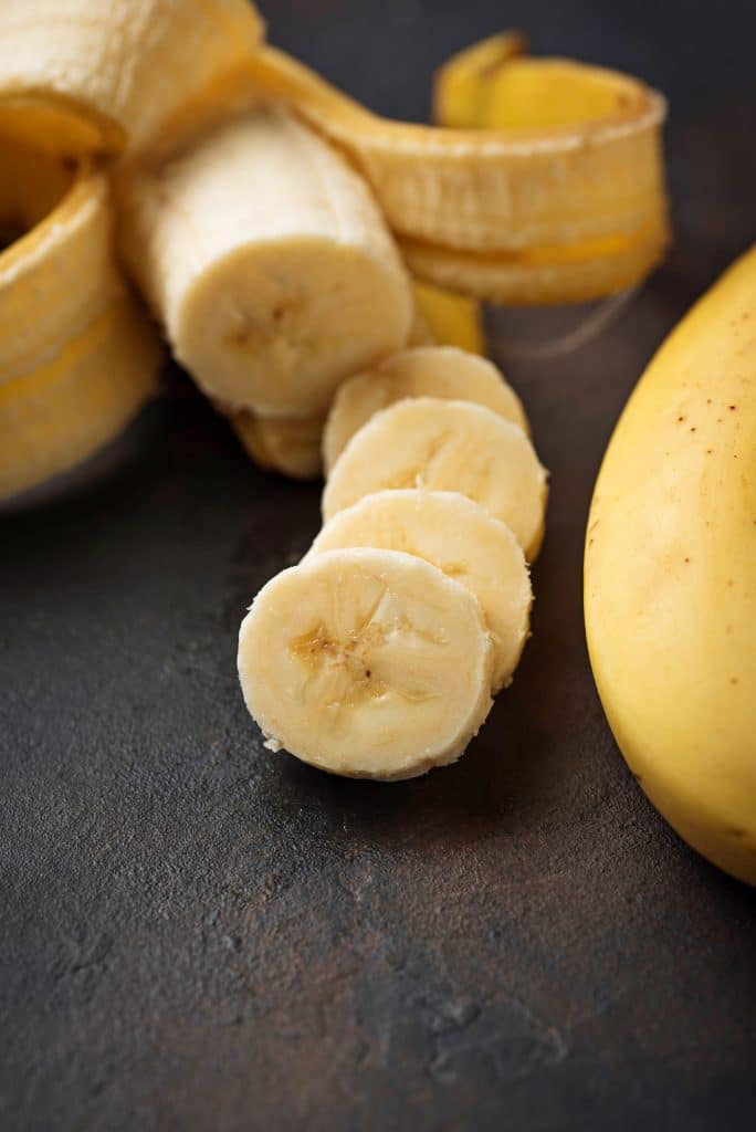 Sliced banana rounds on a dark countertop