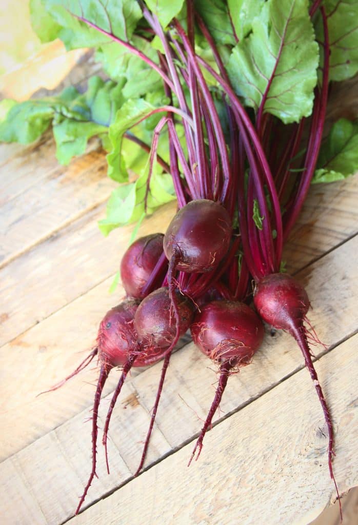 Whole red beets with their greens attached