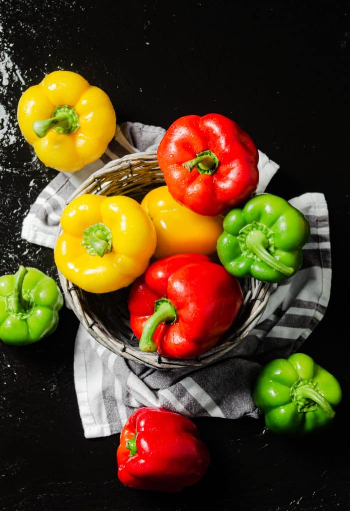 Colorful bell peppers piled in a basket