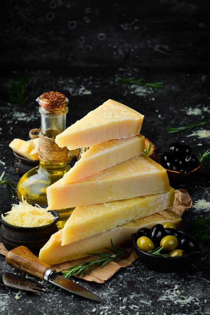 Wedge of firm block cheese ready for grating