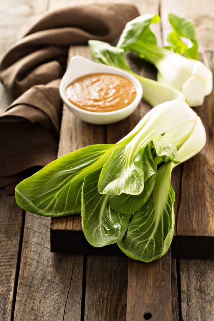Bok choy served with a small dish of dipping sauce