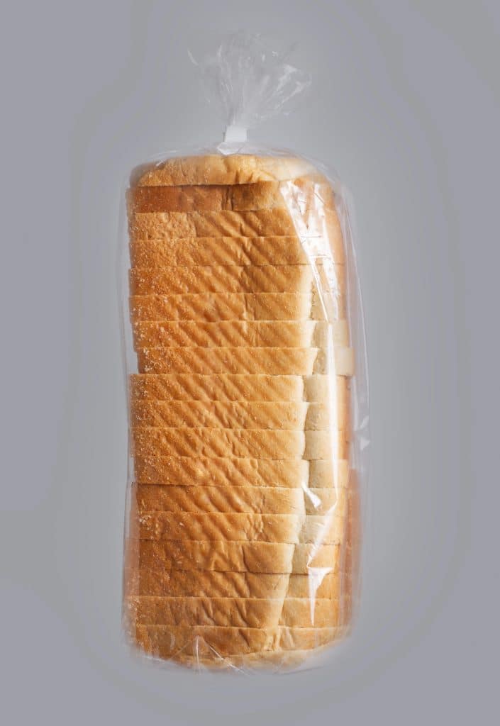 loaf of bread wrapped in plastic packaging on the counter
