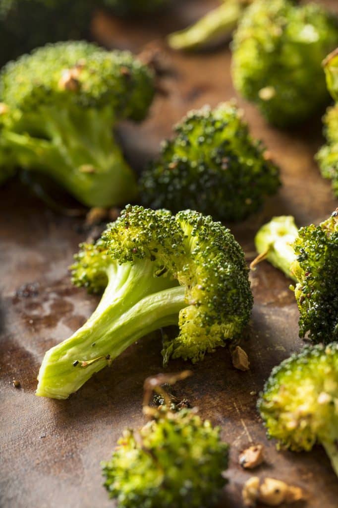 Broccoli crowns arranged on a cutting board