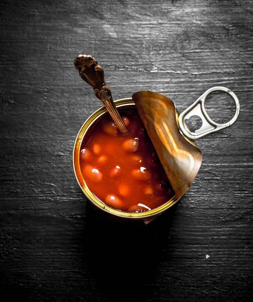 Open can of beans with a spoon