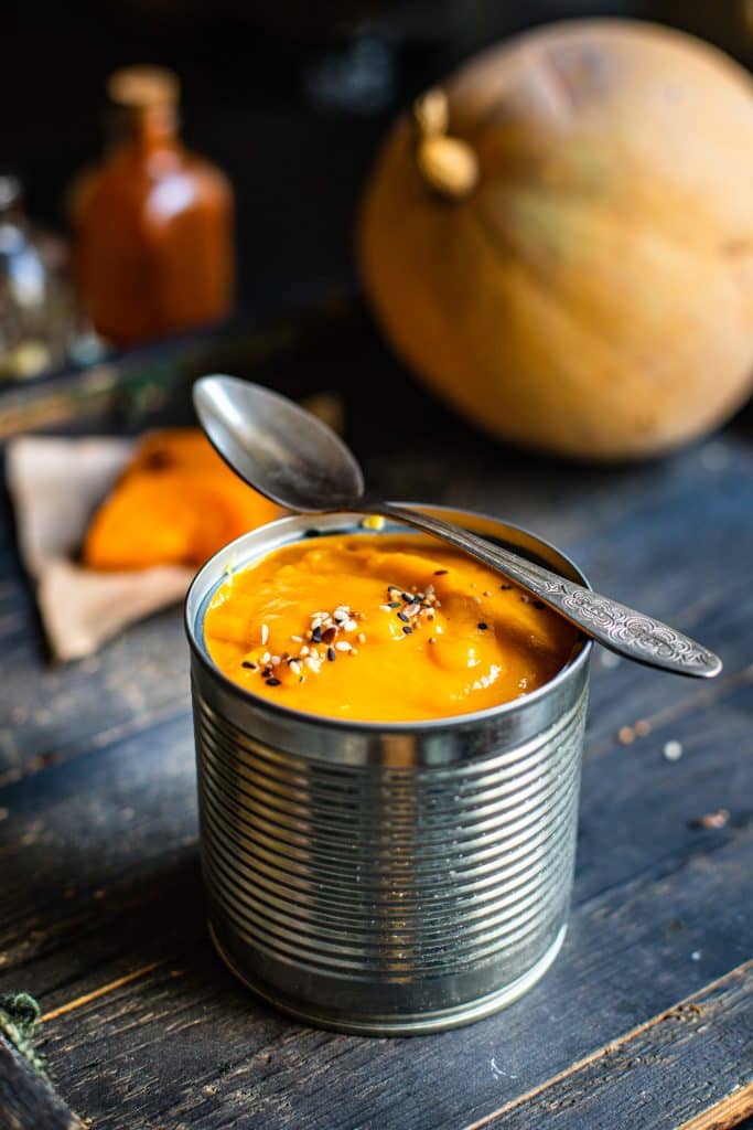 Overhead view of a bowl of creamy orange soup