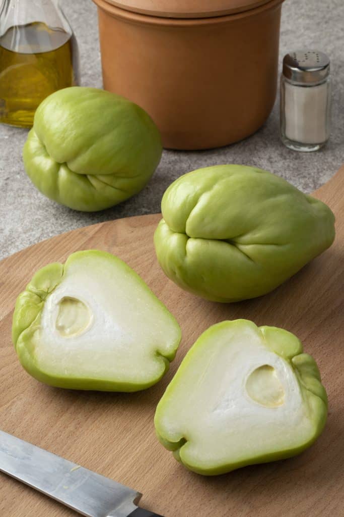 Chayote squash on a cutting board with a knife