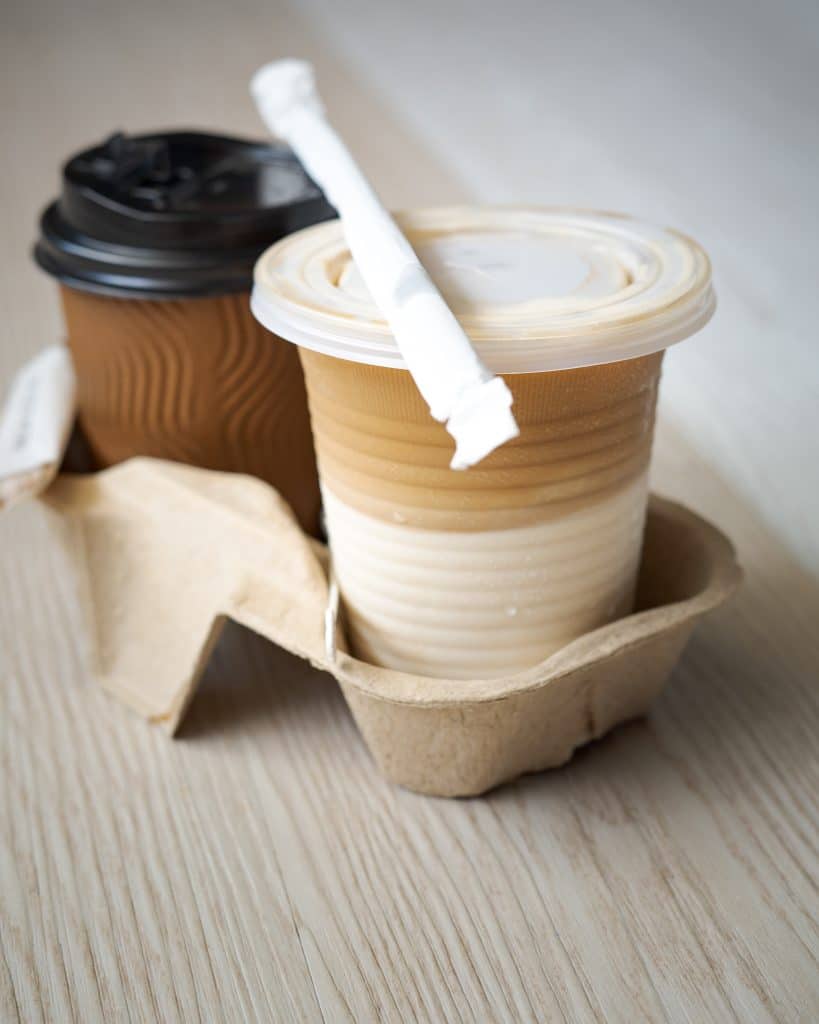 two cups of hot coffee on a wooden table