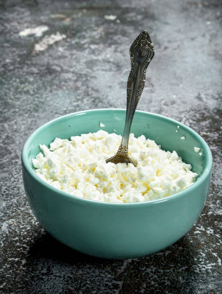 Bowl of cottage cheese with a silver spoon