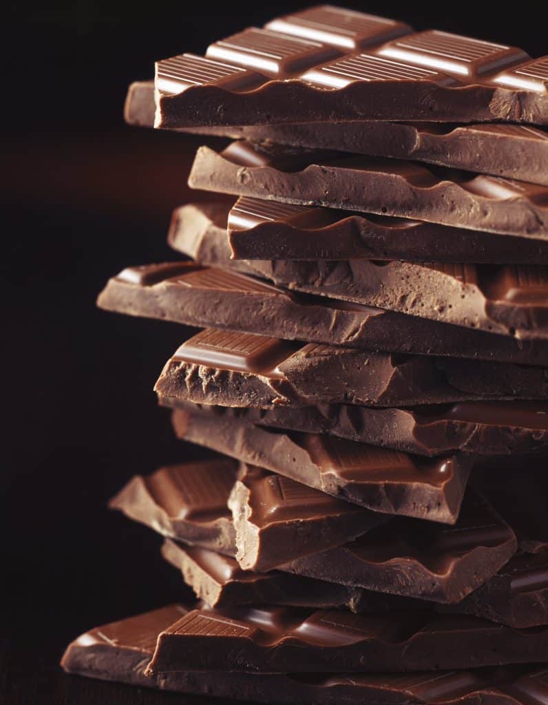 A stack of broken dark chocolate pieces