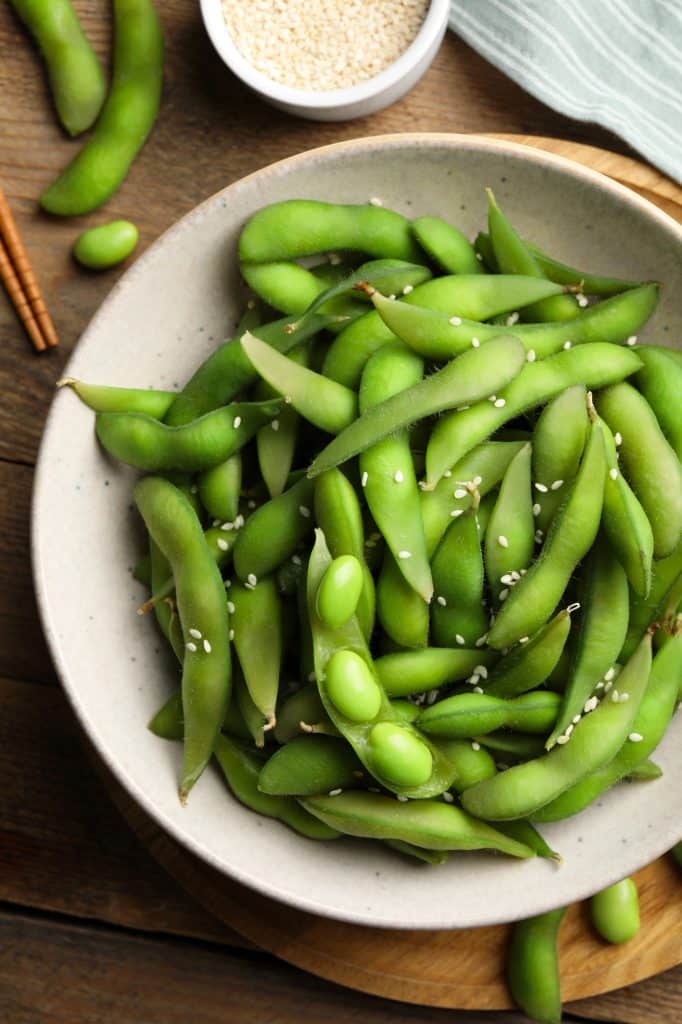 Green edamame pods in a small bowl