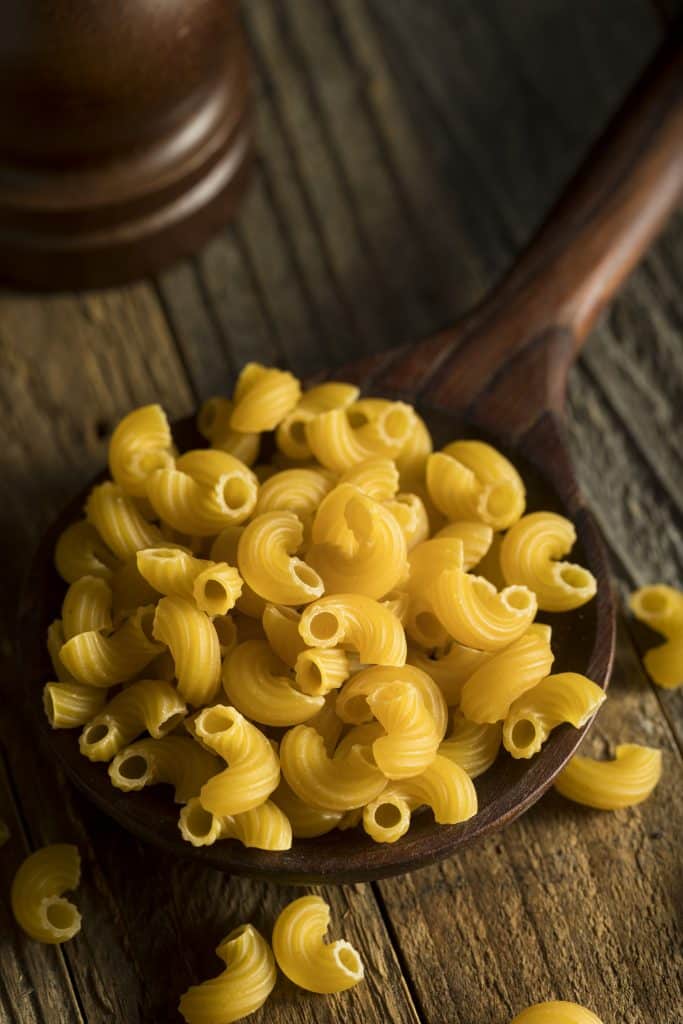 Elbow macaroni in a wooden bowl