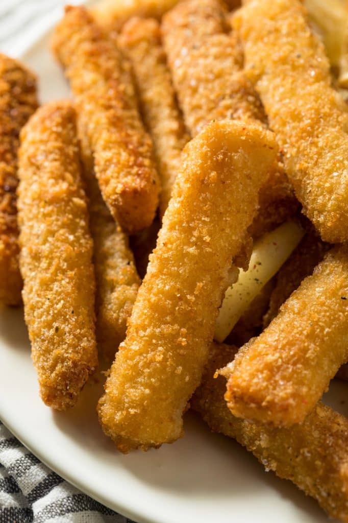 Golden fish sticks on a baking tray