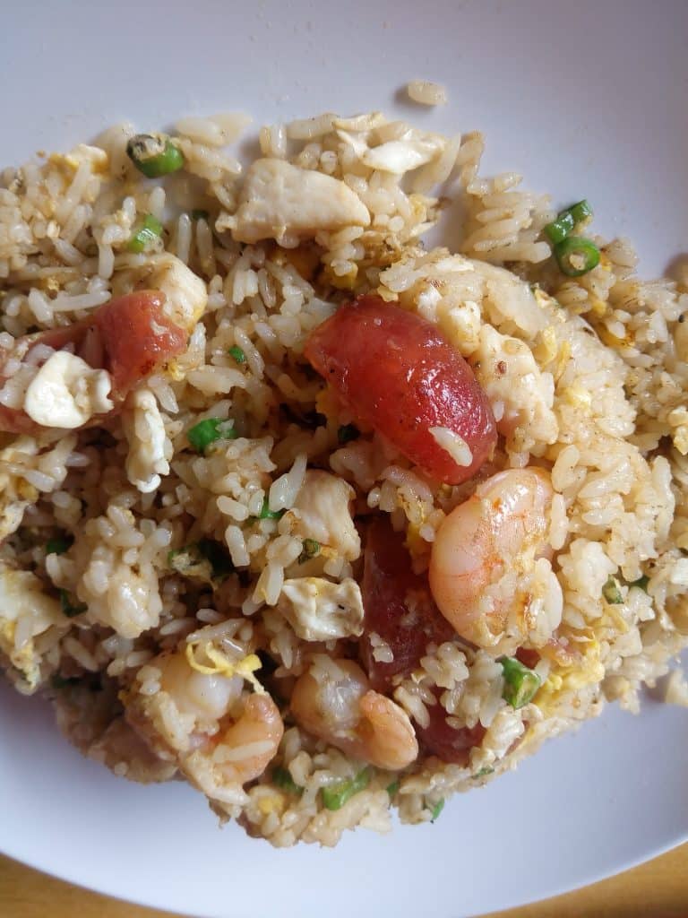 A pan of fried rice with vegetables