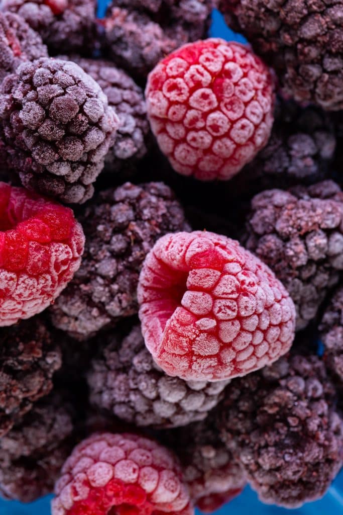 Frosty frozen raspberries in extreme close-up