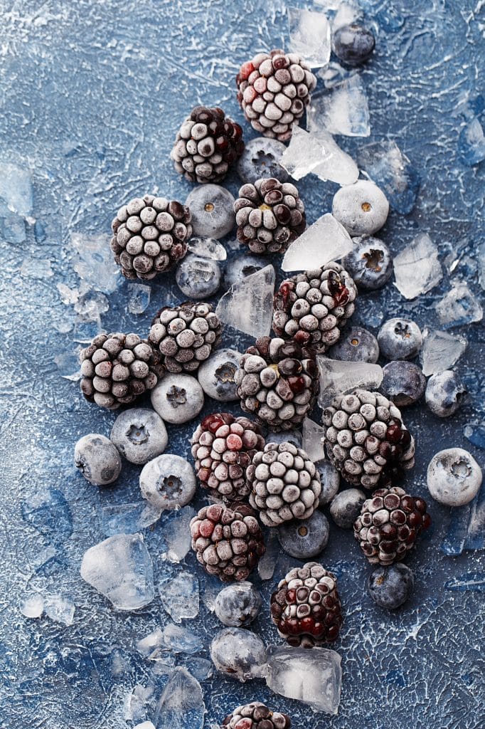 Frozen blueberries scattered together