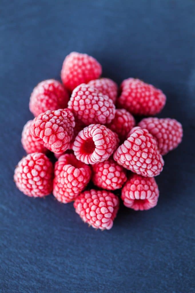 Frozen raspberries piled together