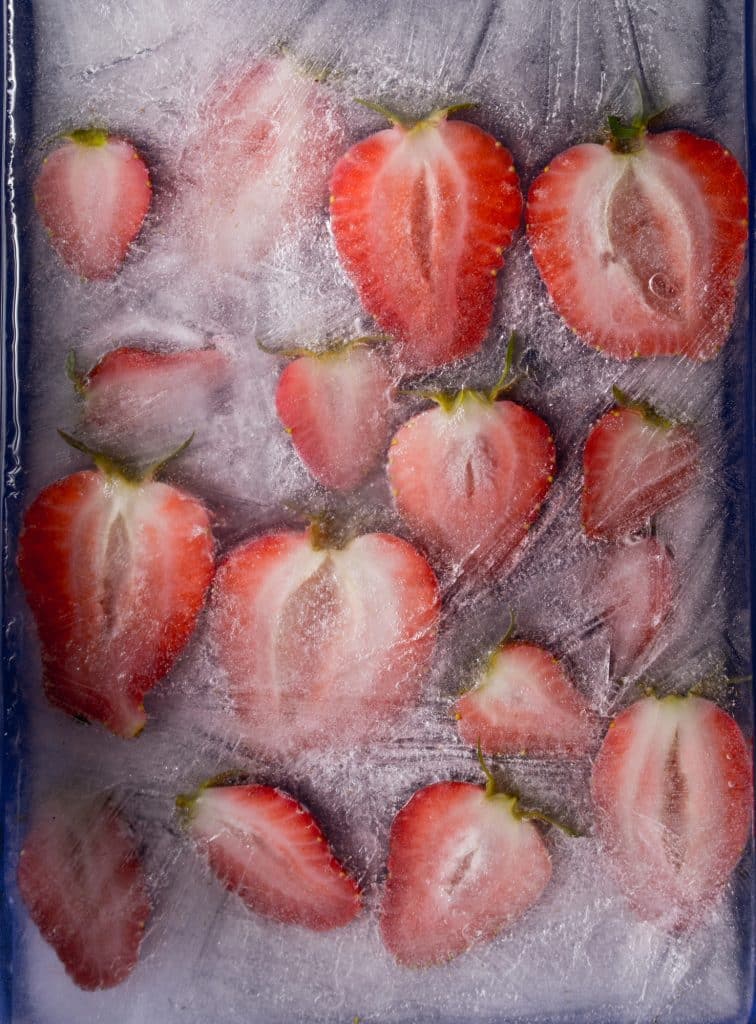 Frozen whole strawberries in a container