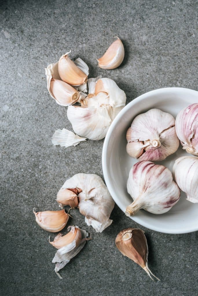 Whole heads of garlic on a wooden table