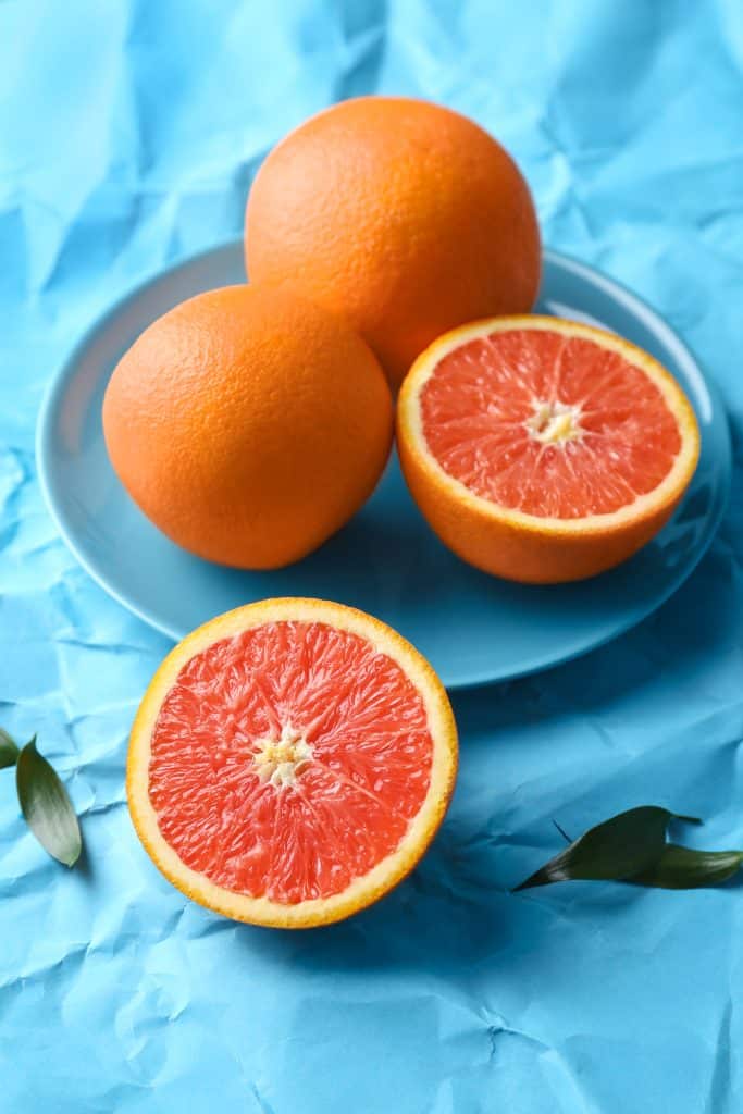 Fresh citrus on a blue paper background
