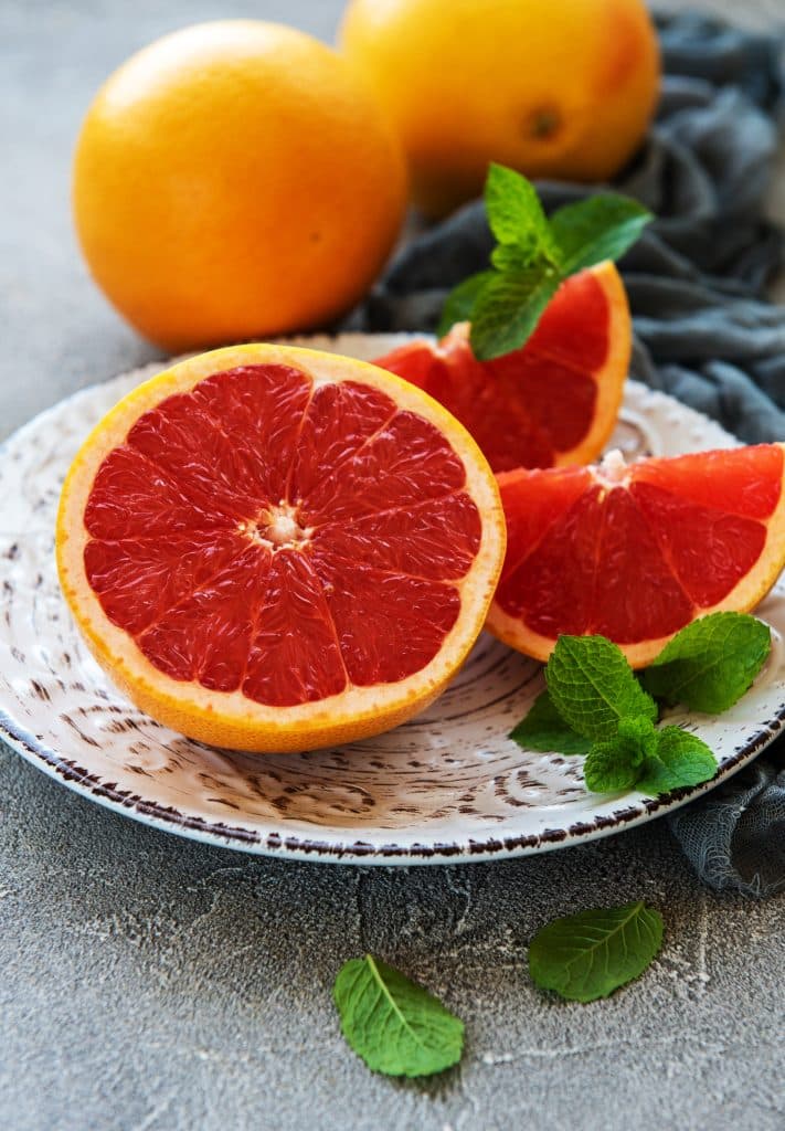 Fresh red grapefruit slices with mint