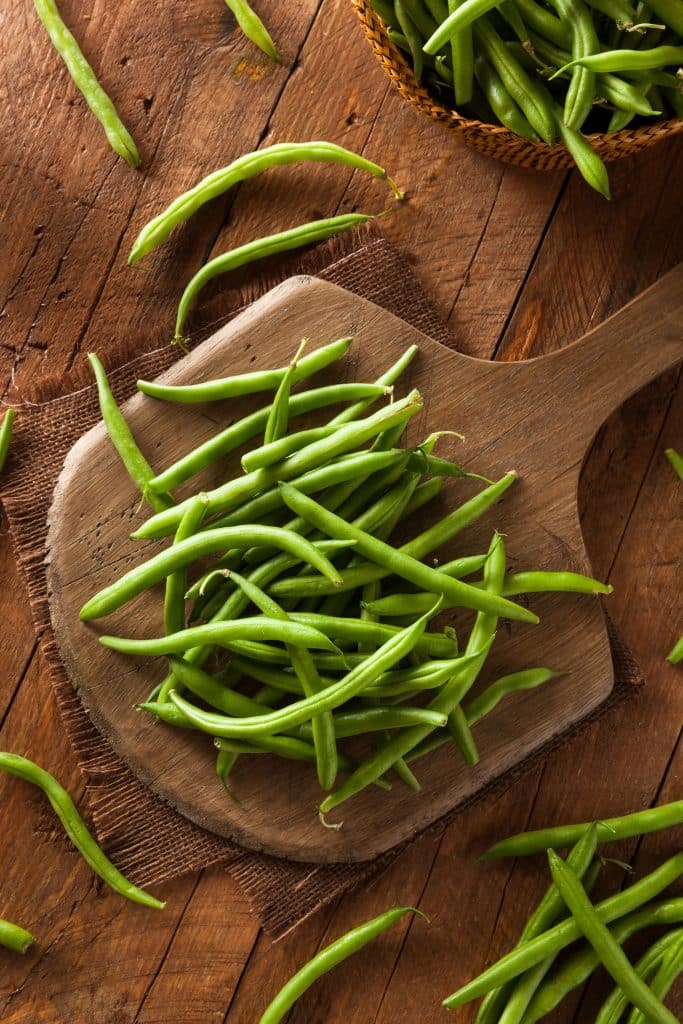 Raw organic green beans piled together