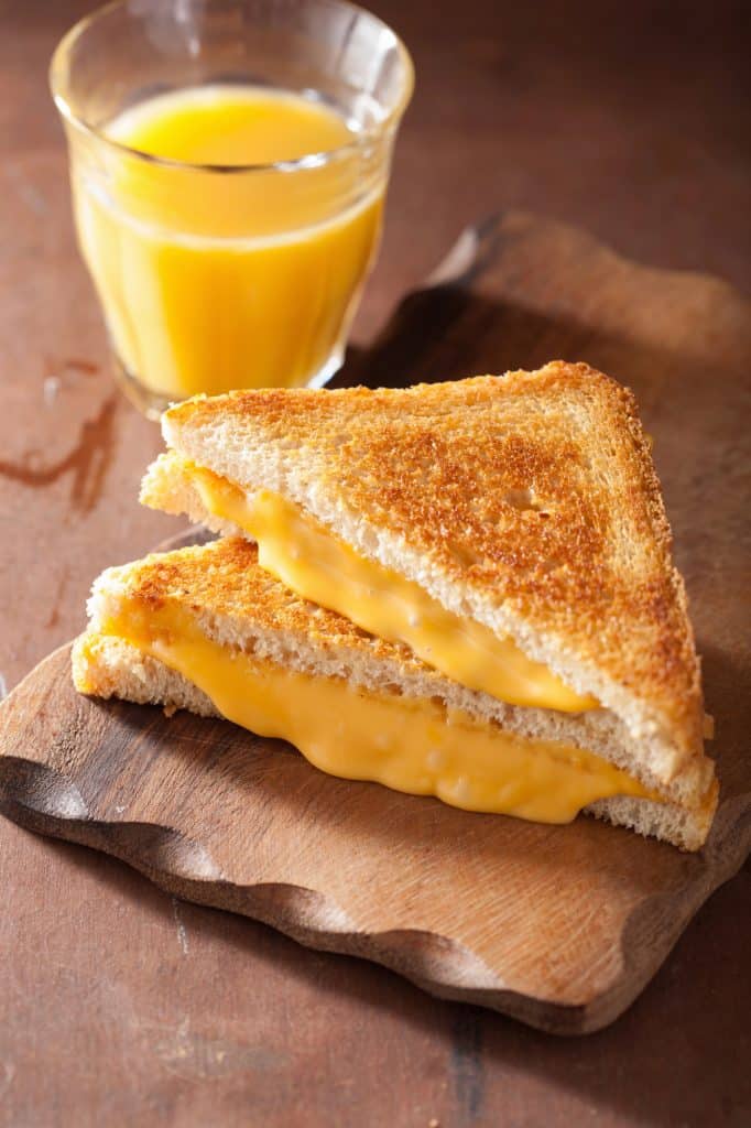 Golden grilled cheese sandwich sliced in half