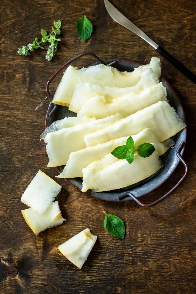 Sliced jicama on a wooden surface