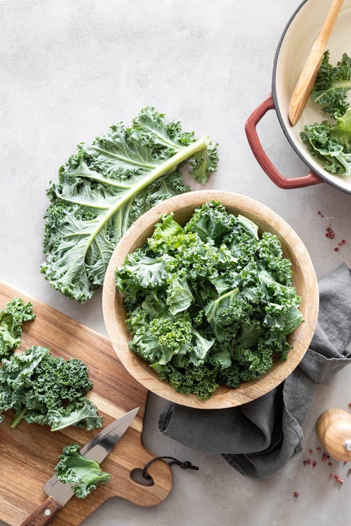 Fresh kale leaves on a wooden cutting board