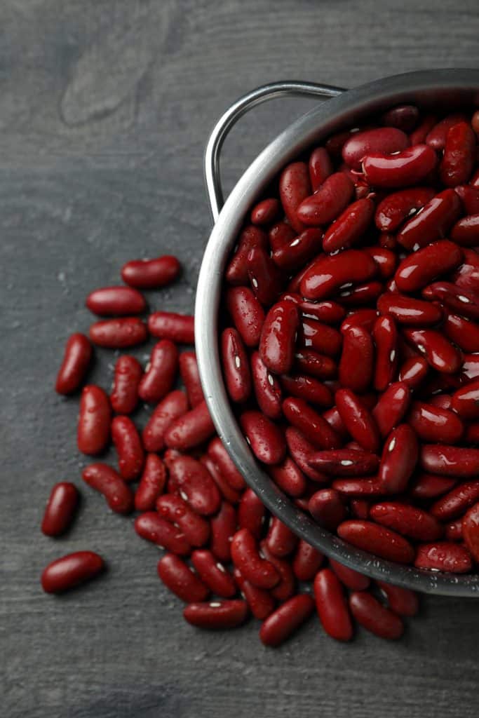 Kidney beans overflowing from a metal bowl
