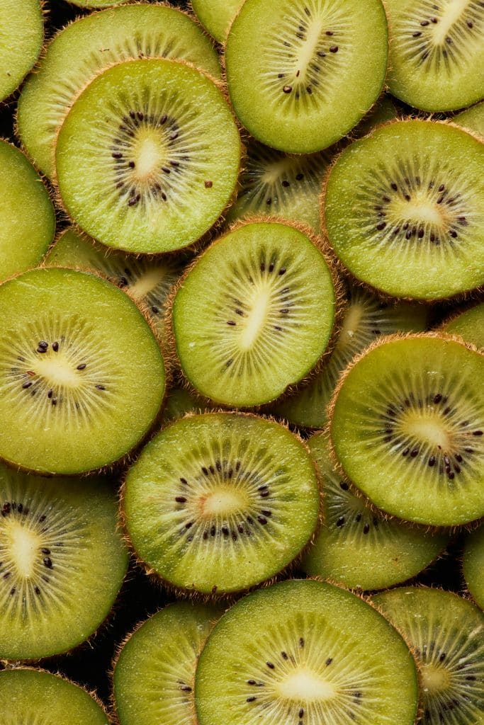 Sliced green kiwi fruit filling the frame