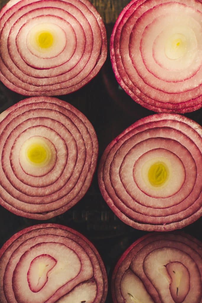 Sliced red onion on a cutting surface