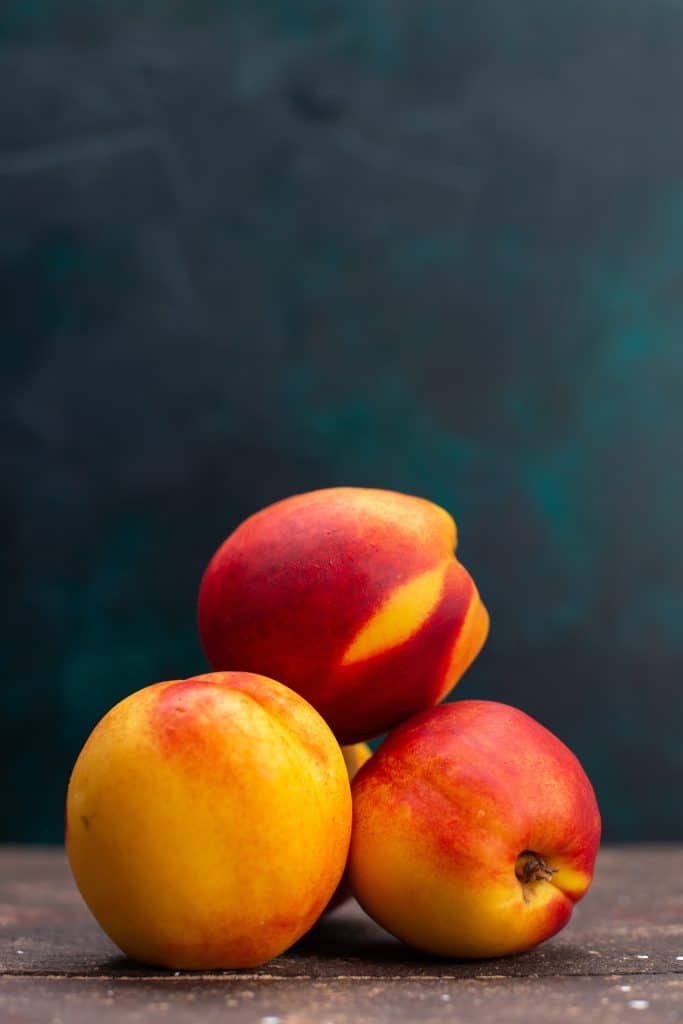 Sweet mellow peaches on a dark background