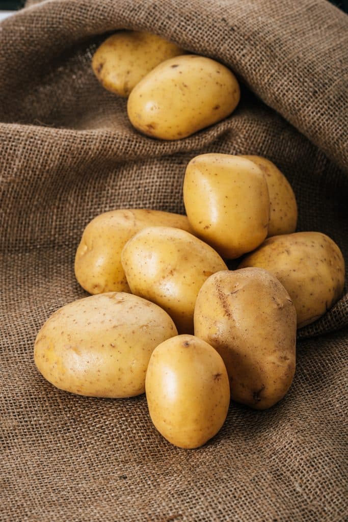 Raw potatoes resting on burlap