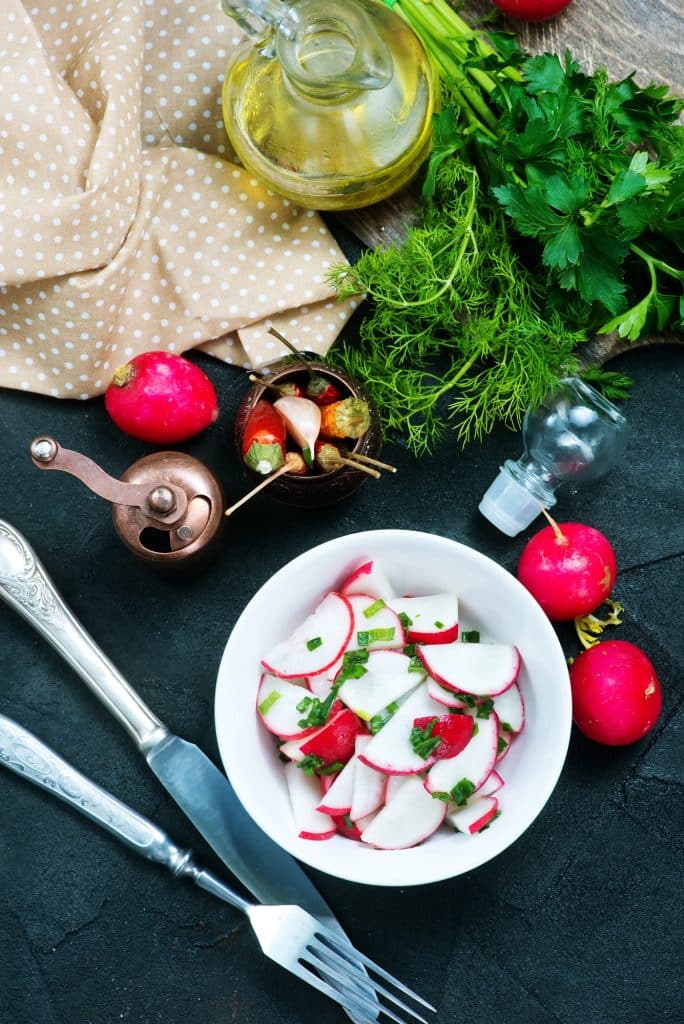Fresh radishes with roots and leaves attached