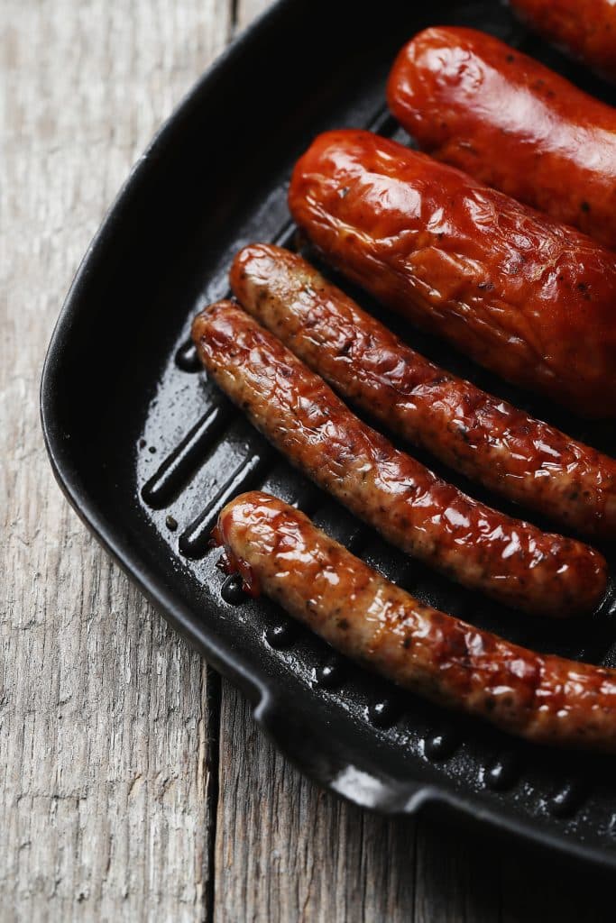 Grilled sausages in a cast iron pan
