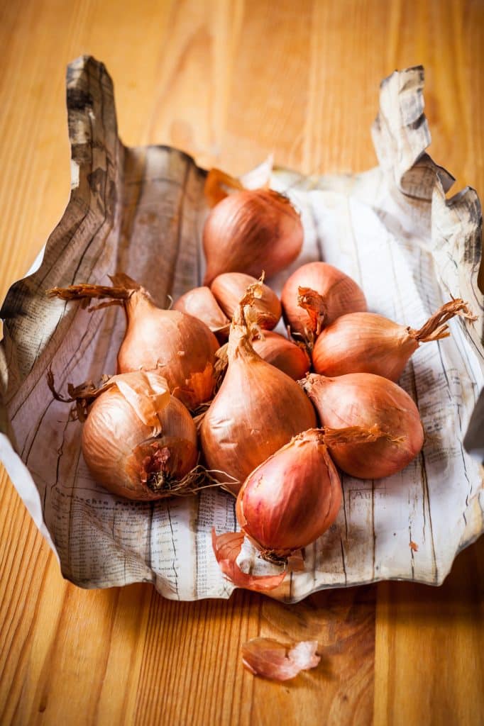 Whole shallots on a countertop