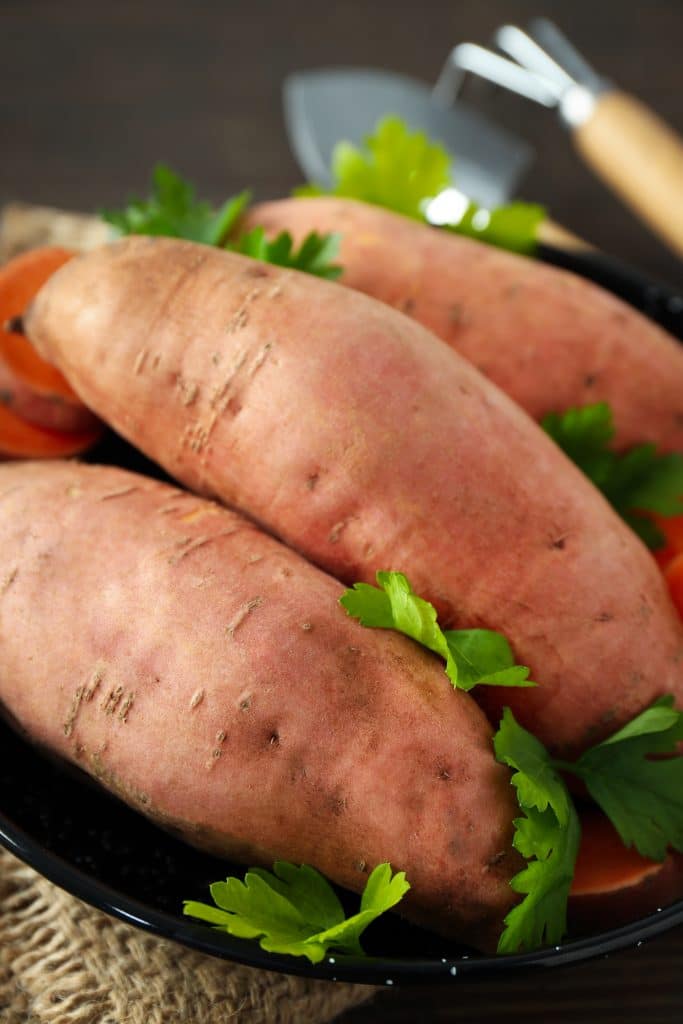 Close-up of a raw sweet potato on a counter