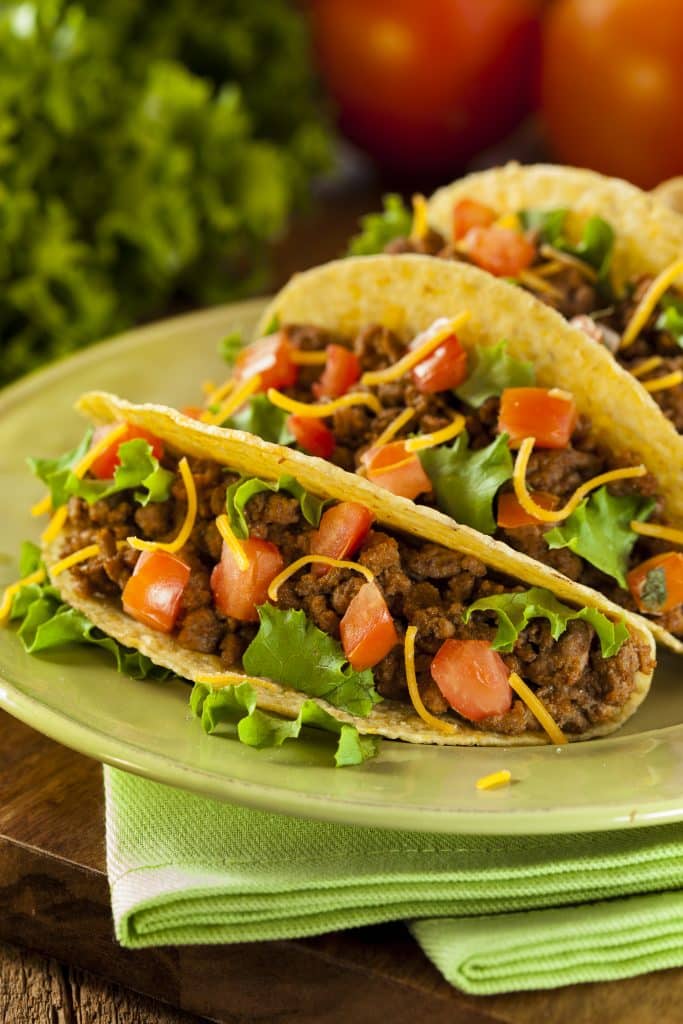 Hard shell tacos filled with ground beef and toppings