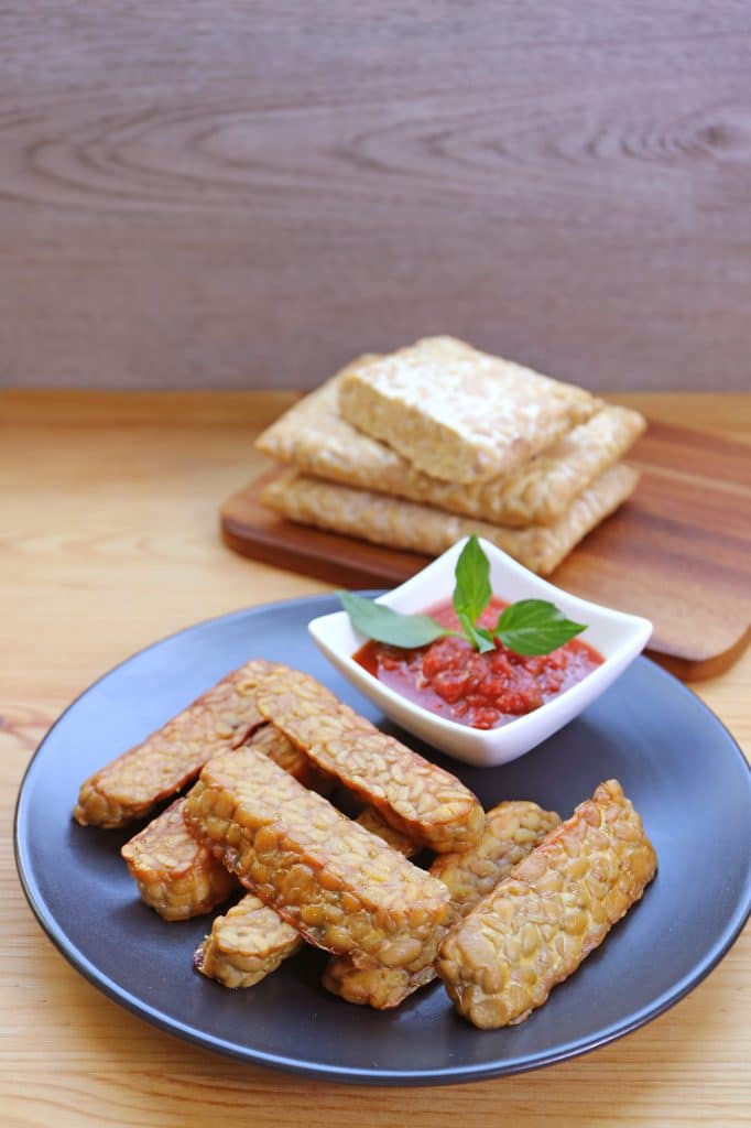 Sliced tempeh on a cutting board