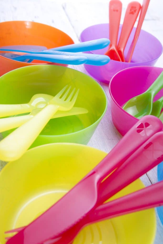 colorful plastic bowls and utensils grouped together