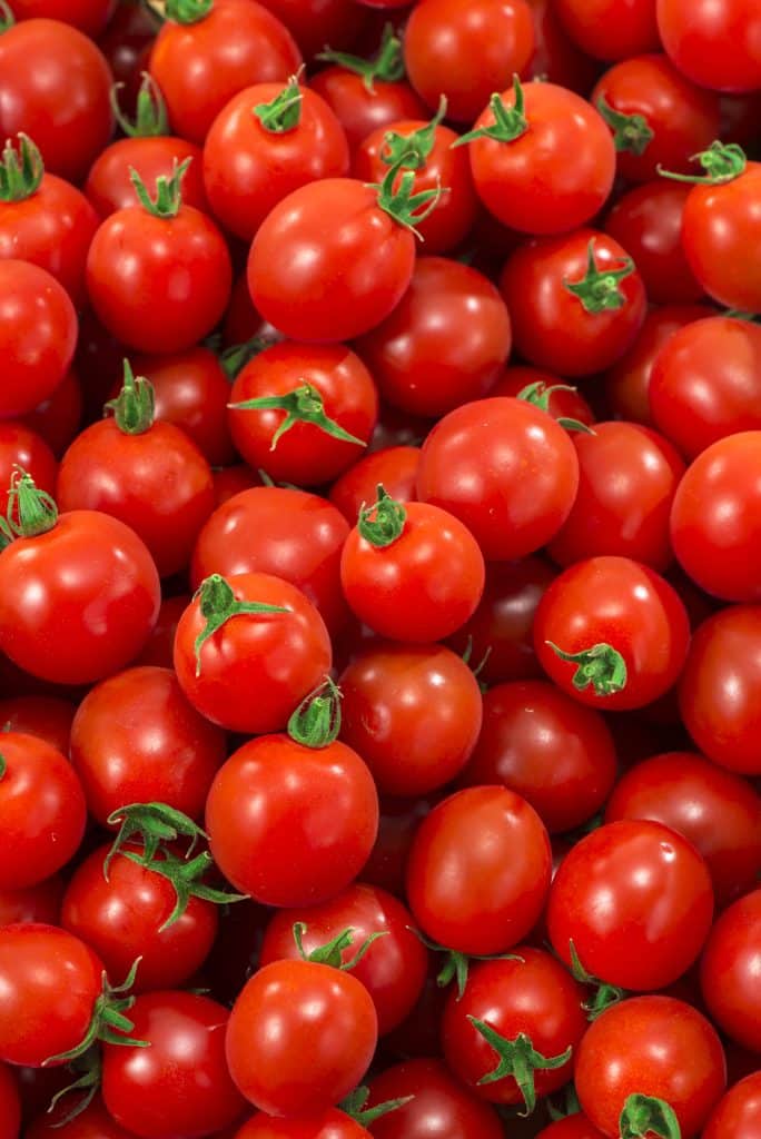 Ripe red tomatoes clustered together