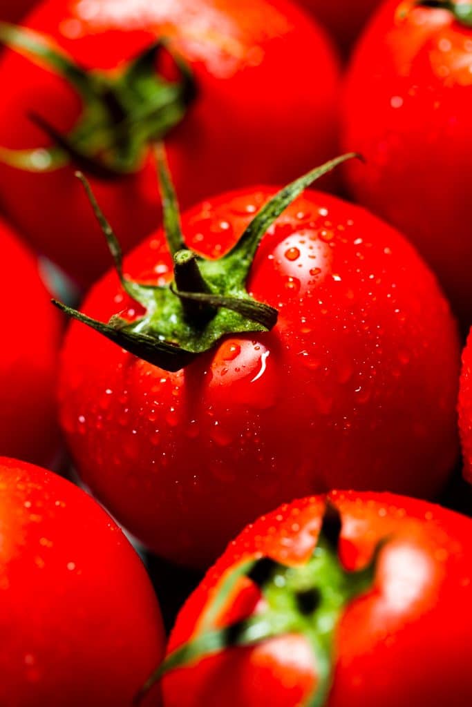 Fresh tomatoes with water droplets on them