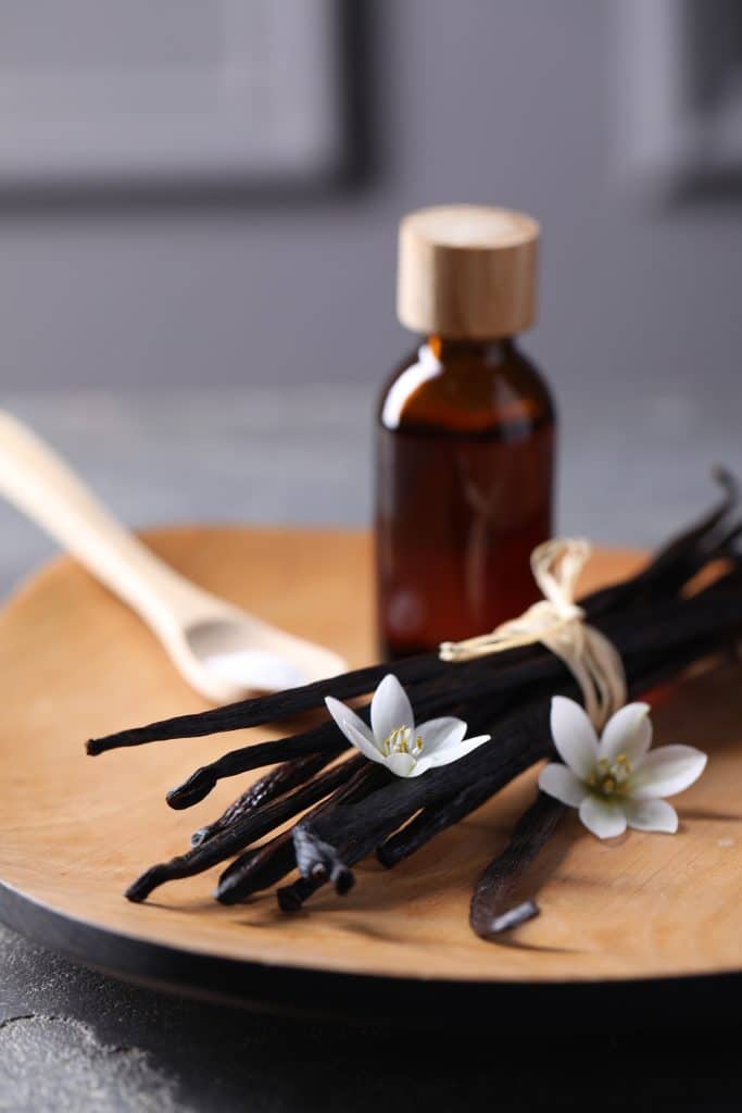 Vanilla beans and extract on a wooden table